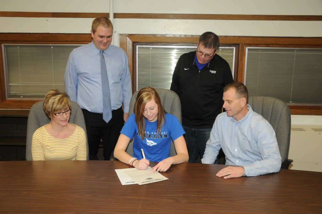 Left to Right: Karen Dick, Greg Veerhusen (Heartland Coach), Mikaelyn Dick, Shawn Reed (Tabor Coach), and Mark Dick. Photo courtesy of Ken Kush, York News Times.