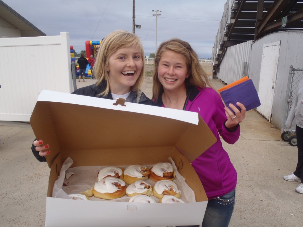 Kim Goossen and Tierney Casper were an enthusiastic sales team as they helped sell homemade cinnamon rolls at the Relay for Life event.