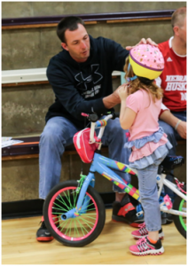 Clark Ribble talks to a preschooler about helmet safety.